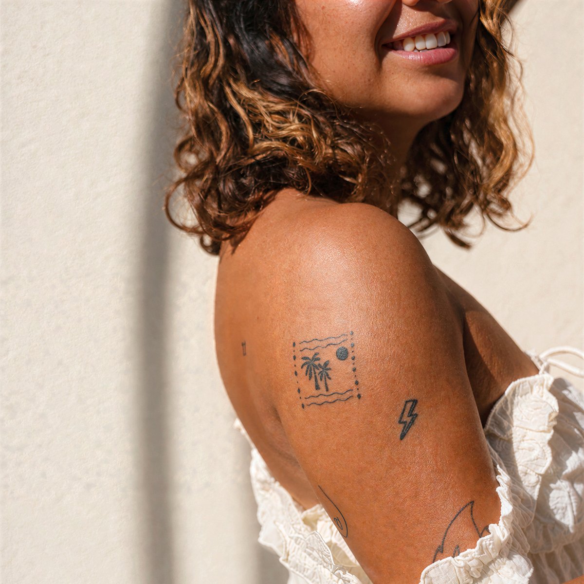 Smiling woman leaning on a wall at home