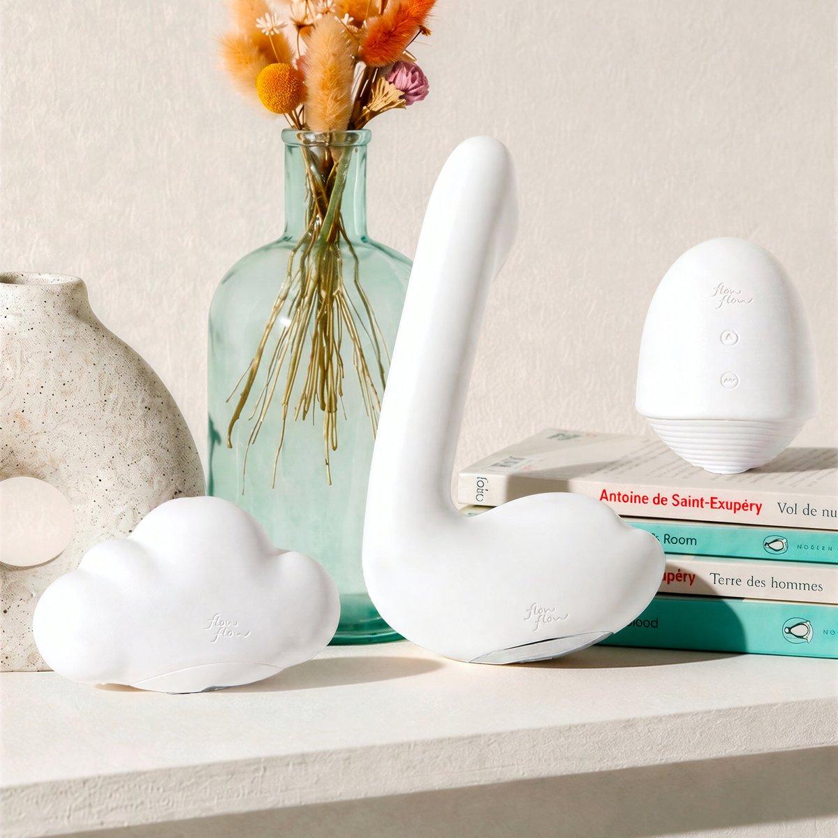 Pépite, Mousse and Plume warming vibrators on a shelf with books and dried flowers