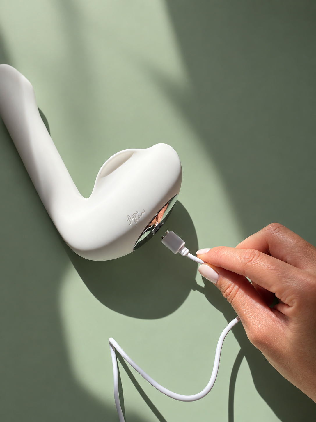 Plume charging port with USB-C cable on a sage green background